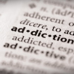 photo of a dictionary focused on the word addiction and addictive is below it out of focus - addictive personality - breakaway hired power