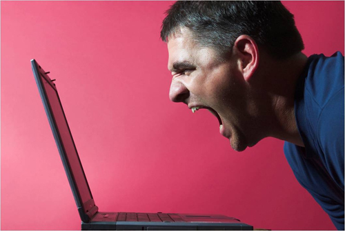 photo of a young man yelling at his laptop - anger management in recovery - hired power breakaway