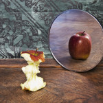 photo of an apple core in front of a mirror with a reflection of a whole apple - body dysmorphic disorder - breakaway hired power
