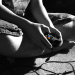 photo of a person holding a game controller in his lap, photo is in black and white with the game controller in color - gaming addiction - breakaway hired power