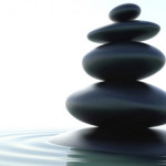 photo of four round smooth stones stacked on top of each other, resting peacefully - meditation in recovery - breakaway hired power