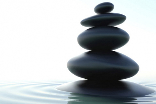 photo of four round smooth stones stacked on top of each other, resting peacefully - meditation in recovery - hired power breakaway