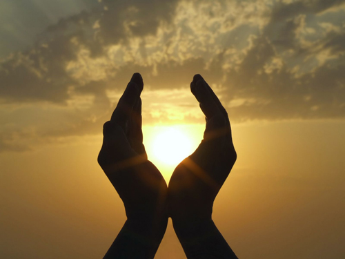 photo of a silhouette of two hands cupping the sun at dawn - breakaway hired power - spirituality in recovery