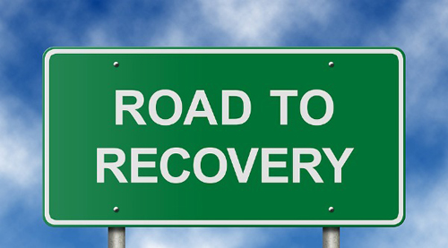 photo of a street sign that says Road to Recovery - breakaway hired power - long term addiction treatment - is longer better